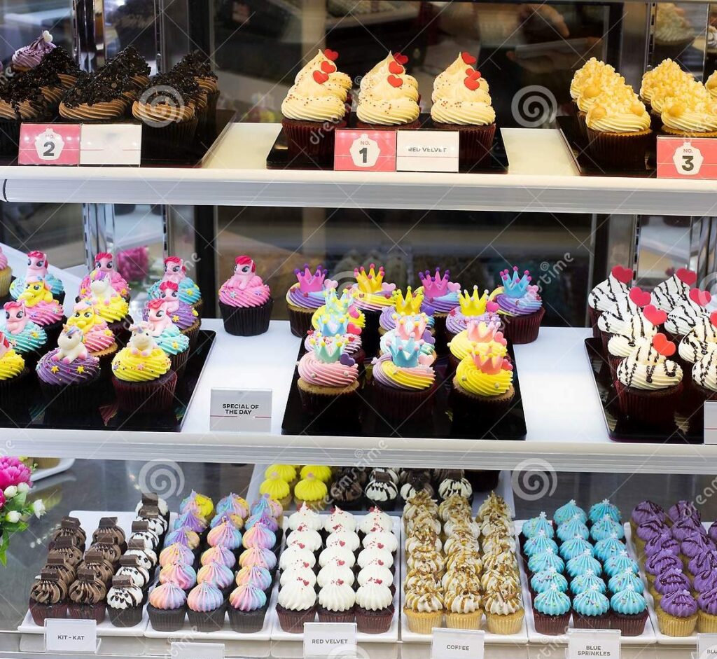 Photo of a cupcake display cake arrayed with dozens of colourful and delicious cupcakes.
