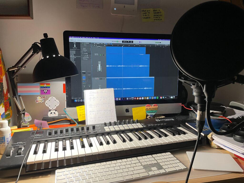 Teiya's home studio with keyboard, monitor and mic set up.
