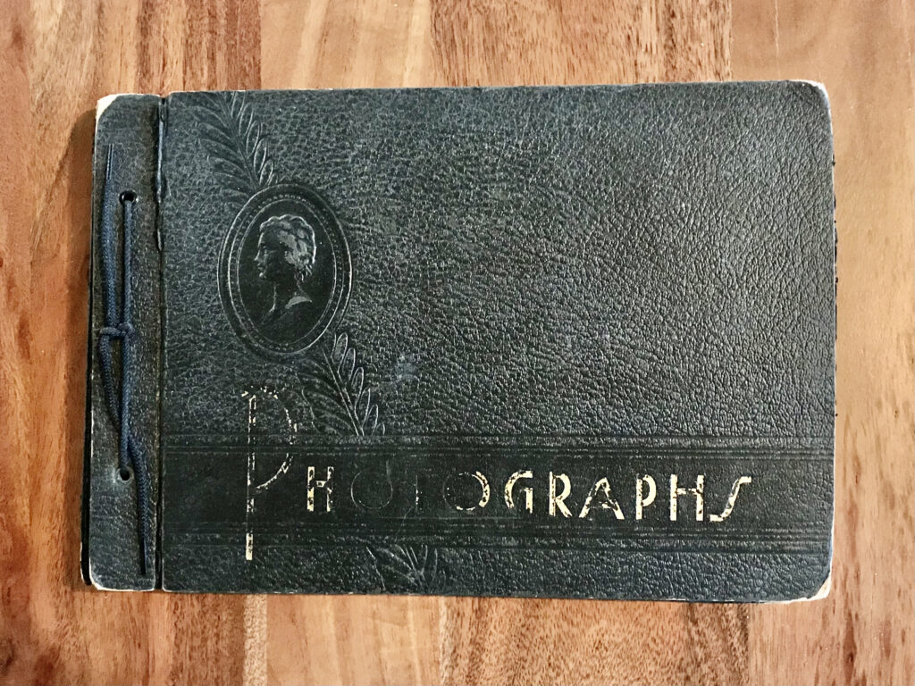 a very old black leather photo album belonging to Lillian's mother. 